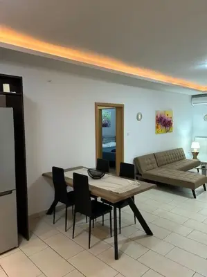 a living room with a table and chairs and a couch at Κεντρικό διαμέρισμα στην Αθηνα in Athens
