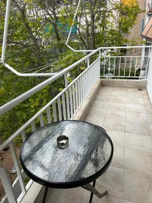 a glass table on top of a balcony at Κεντρικό διαμέρισμα στην Αθηνα in Athens