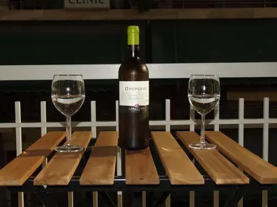 a bottle of wine and two glasses on a table at Near by Acropolis in Athens
