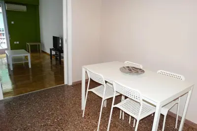 a white table and chairs in a room at Near by Acropolis in Athens