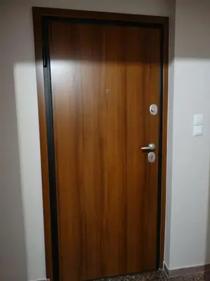 a wooden door in the corner of a room at Near by Acropolis in Athens