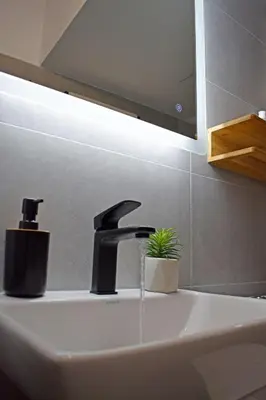 a sink with a faucet in a bathroom at Maya Studio Piraeus in Piraeus