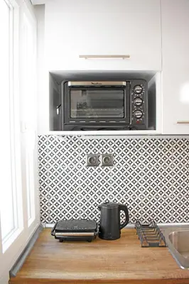 a kitchen counter with a toaster oven above a microwave at Maya Studio Piraeus in Piraeus