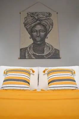 a painting above a bed with two pillows at Maya Studio Piraeus in Piraeus