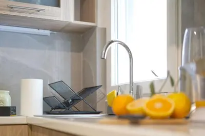 a kitchen counter with a sink with lemons on it at Vibrant 2BR in Koukaki in Athens