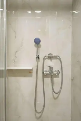 a shower in a bathroom with a glass door at Vibrant 2BR in Koukaki in Athens