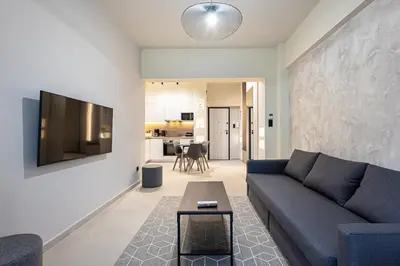 a living room with a couch and a table at Stylish Central Athens Apartment in Athens