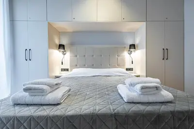 a bedroom with a large bed with towels on it at Stylish Central Athens Apartment in Athens