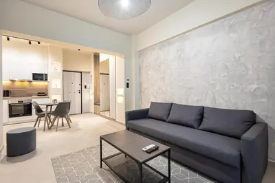 a living room with a couch and a table at Stylish Central Athens Apartment in Athens