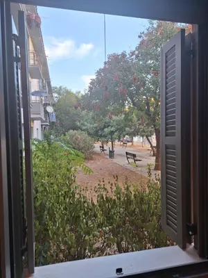 an open window with a view of a street at Homy in Athens