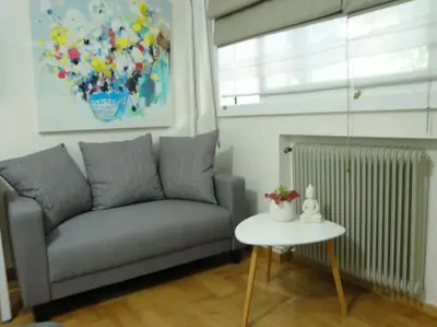a living room with a couch and a table at Lux Studio Apartment at Kolonaki in Athens