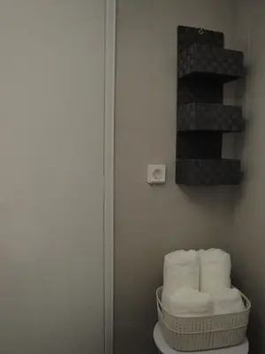 a bathroom with a toilet with a pile of towels at Lux Studio Apartment at Kolonaki in Athens
