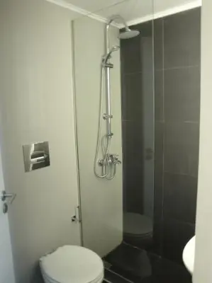 a bathroom with a toilet and a glass shower at Lux Studio Apartment at Kolonaki in Athens