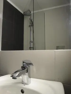 a bathroom sink with a mirror and a shower at Lux Studio Apartment at Kolonaki in Athens