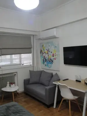 a living room with a couch and a table at Lux Studio Apartment at Kolonaki in Athens