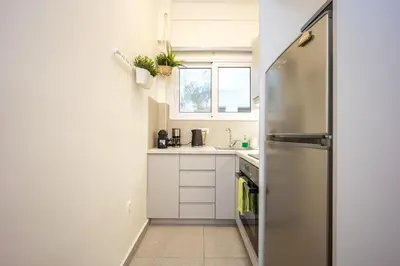 a small kitchen with a stainless steel refrigerator at DownTown Vibes 2 in Athens