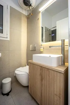 a bathroom with a sink and a toilet and a mirror at DownTown Vibes 2 in Athens