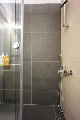 a bathroom with a shower with a glass door at DownTown Vibes 2 in Athens