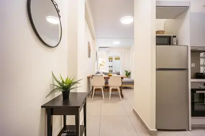 a kitchen and dining room with a refrigerator and a table at DownTown vibes #1 in Athens