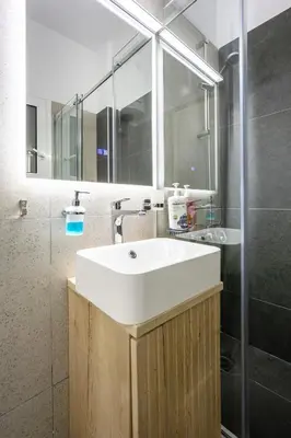 a bathroom with a white sink and a shower at DownTown vibes #1 in Athens