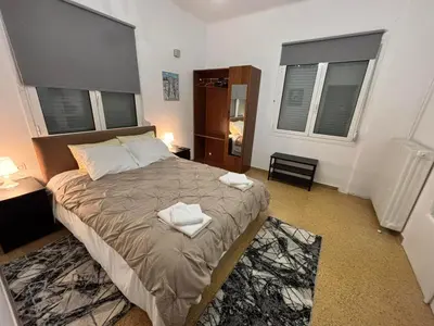 a bedroom with a bed with two towels on it at VK apartment in Athens