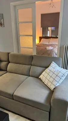 a couch in a living room with a bedroom at VK apartment in Athens