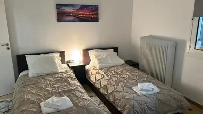two beds sitting next to each other in a room at VK apartment in Athens