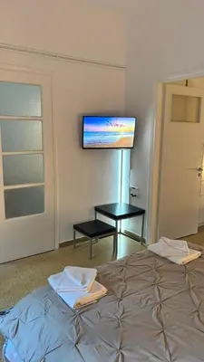 a bedroom with a bed and a flat screen tv at VK apartment in Athens