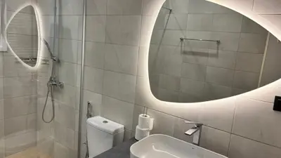 a bathroom with a sink and a mirror and a toilet at VK apartment in Athens