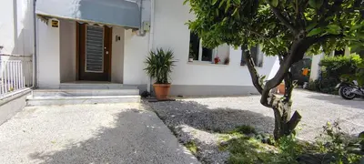 a house with a tree in front of it at VK apartment in Athens