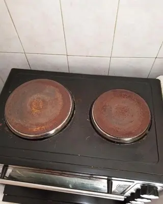 two cakes are sitting on top of a stove at Simple apartment in Athens