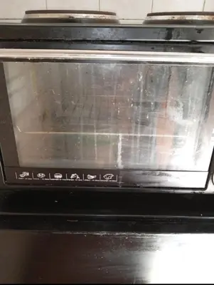 a toaster oven with its door open in a kitchen at Simple apartment in Athens