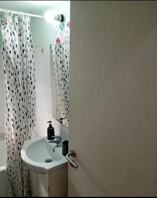 a bathroom with a sink and a shower curtain at Simple apartment in Athens
