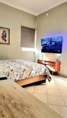 a bedroom with a bed and a flat screen tv at Διαμέρισμα στο Χαλάνδρι in Athens