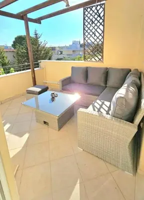 a living room with a couch and a table at Διαμέρισμα στο Χαλάνδρι in Athens