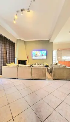 a large living room with couches and a tv at Διαμέρισμα στο Χαλάνδρι in Athens