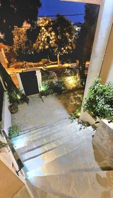 an outside view of a patio at night at Διαμέρισμα στο Χαλάνδρι in Athens