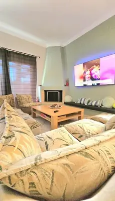 a living room with a couch and a tv at Διαμέρισμα στο Χαλάνδρι in Athens