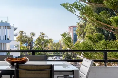 a table and chairs on a balcony with a view at Elegant & Roomy 3-Bedroom Apartment in the Heart of Glyfada in Athens