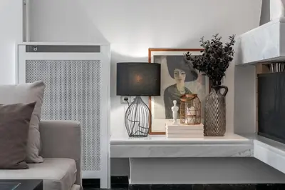 a living room with a couch and a table with a lamp at Elegant & Roomy 3-Bedroom Apartment in the Heart of Glyfada in Athens
