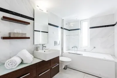 a bathroom with a sink and a tub and a toilet at Elegant & Roomy 3-Bedroom Apartment in the Heart of Glyfada in Athens