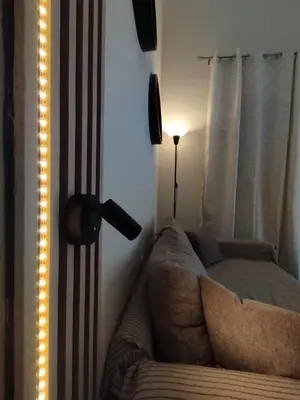 a living room with a couch and a lamp at Cozy Attiki apartment by MPS in Athens