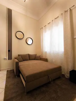 a bedroom with a bed and a mirror on the wall at Cozy Attiki apartment by MPS in Athens