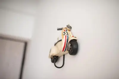 a toy motorcycle is hanging on a wall at The Athens Getaway Apartment in Athens