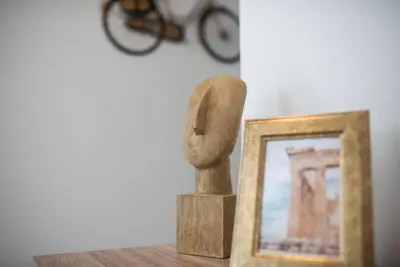 a statue sitting next to a picture next to a frame at The Athens Getaway Apartment in Athens