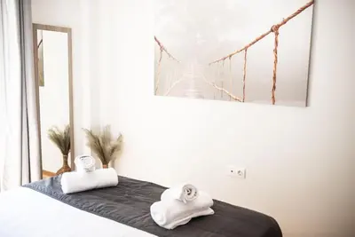 a bedroom with a bed with towels on it at The Athens Getaway Apartment in Athens