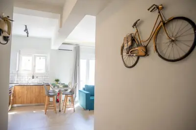 a bike hanging on a wall in a living room at The Athens Getaway Apartment in Athens