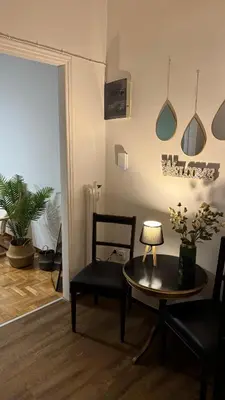 a living room with a table and a chair at Olēa House at Monastiraki in Athens