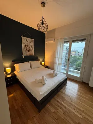 a bedroom with a large bed with two towels on it at Olēa House at Monastiraki in Athens