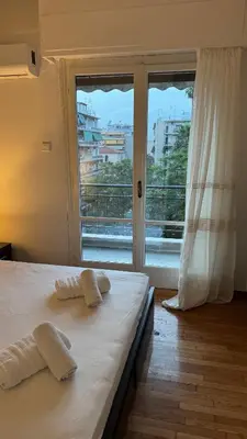 a bedroom with a bed with two towels on it at Olēa House at Monastiraki in Athens